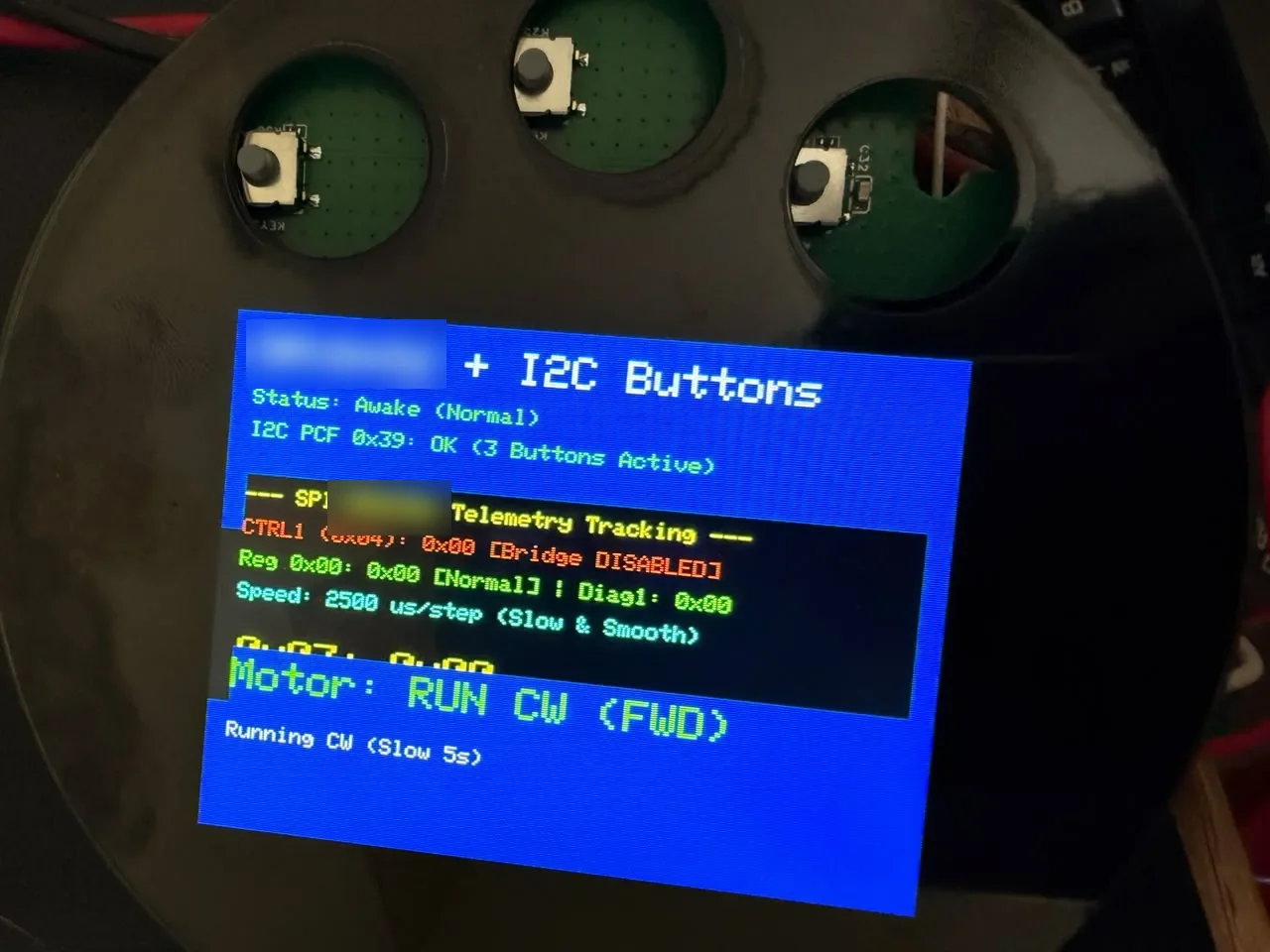 Prototype faceplate showing a stepper driver telemetry screen with three I2C buttons above